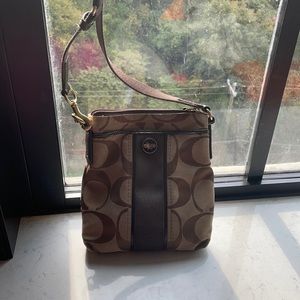 A brown coach over the shoulder bag.